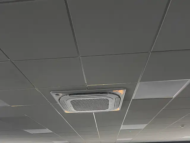 Office ceiling cassette air conditioning, London Four-way ceiling cassette air conditioning unit fitted into a suspended office ceiling
