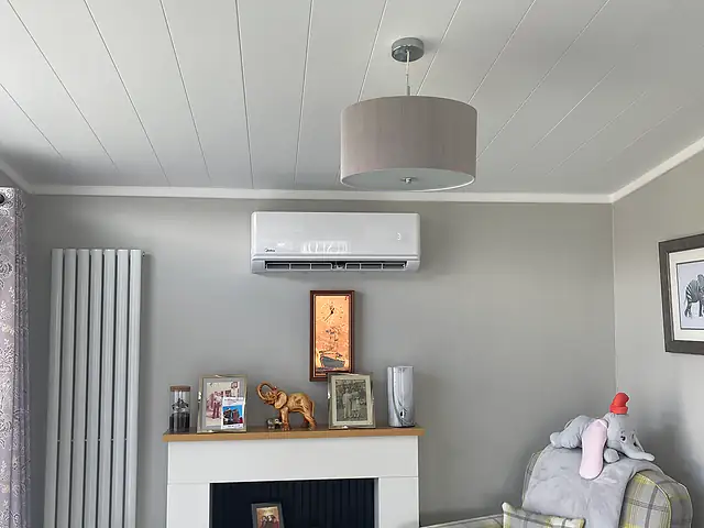 Air Conditioning Installation in London Air Conditioning Installation in London: a split air conditioning unit above a living room fireplace